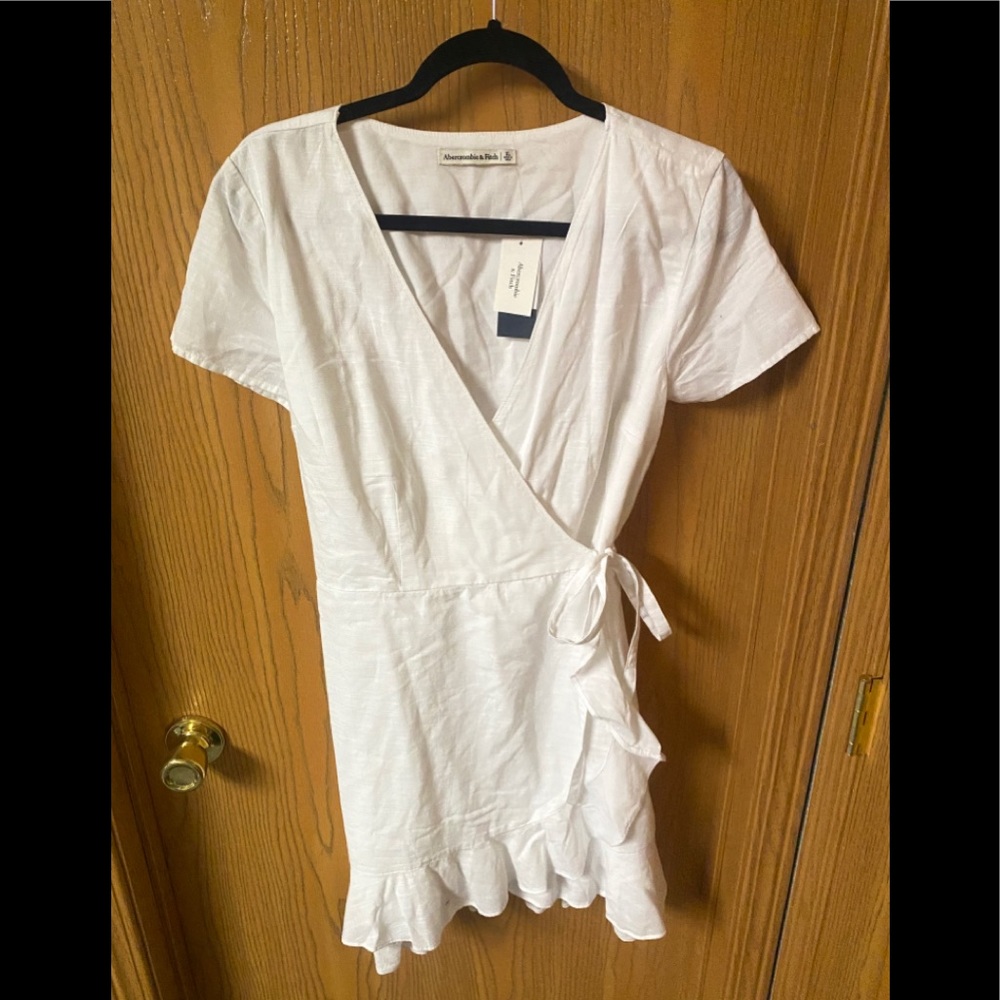 NWT stunning white wrap ruffle hem dress